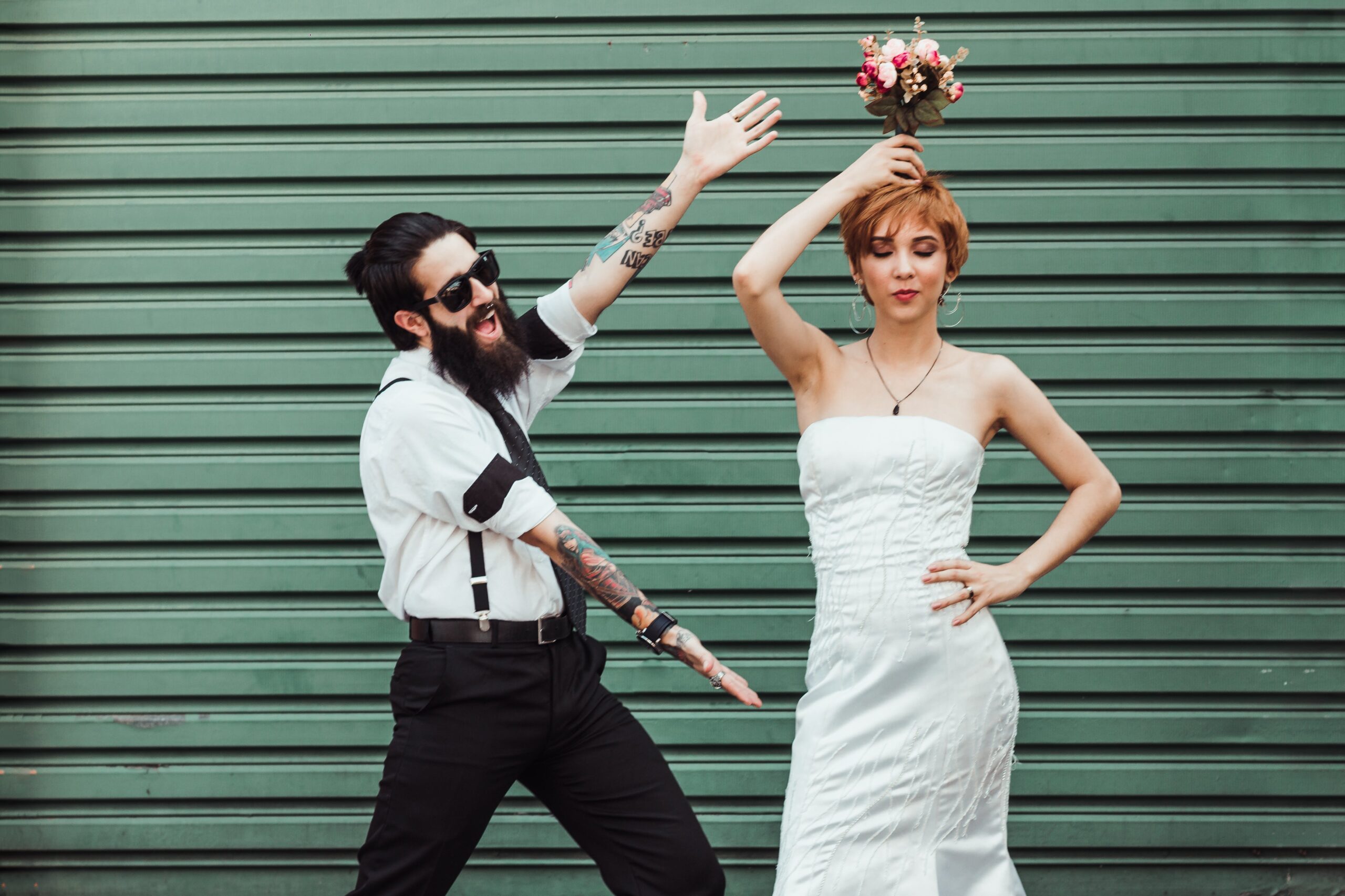 bride and groom, bride is holding her bouquet above her head
